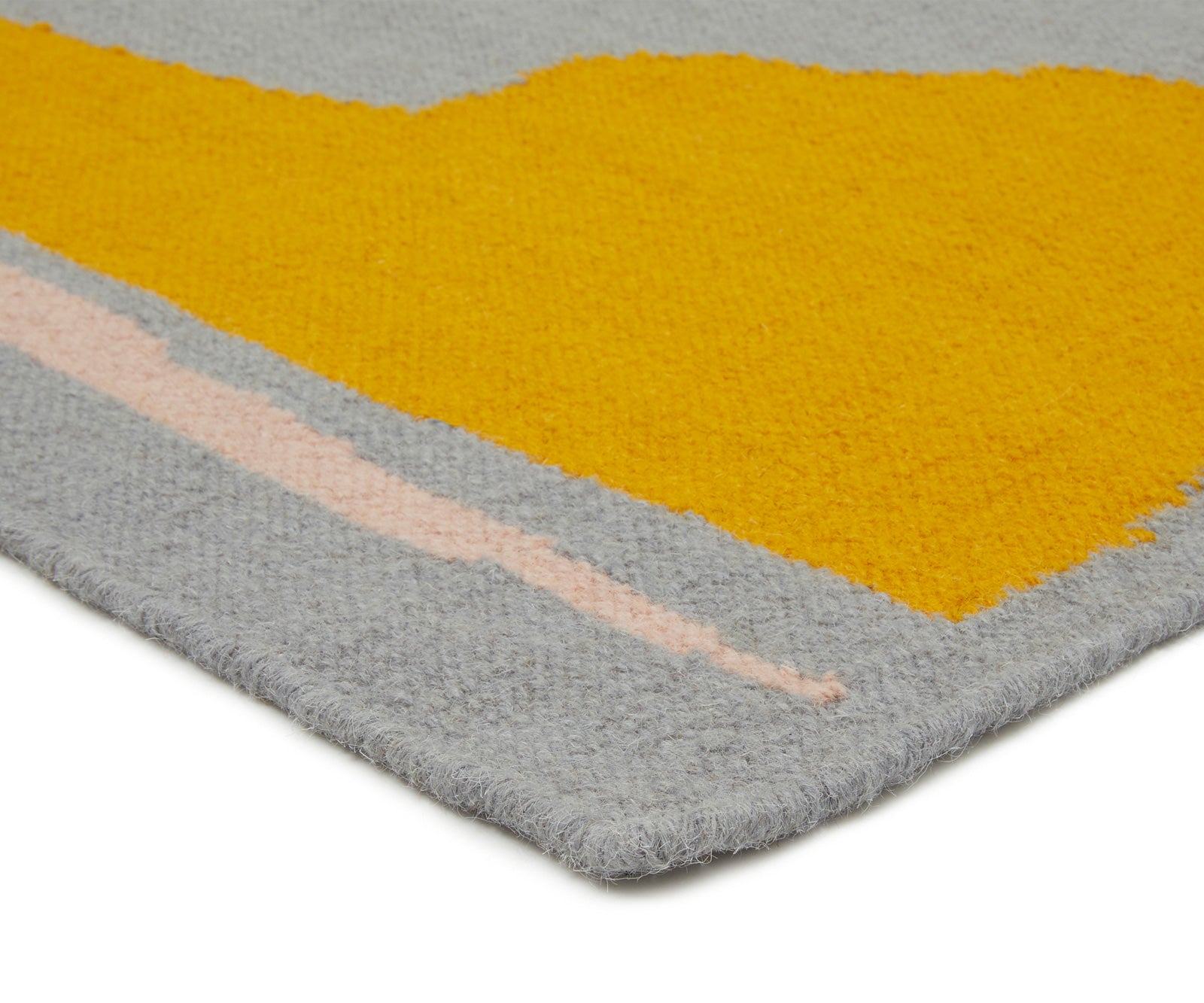 A 100% wool yarn flat weave rug from Cold Picnic. An abstract design featuring blue/grey with yellow and black
